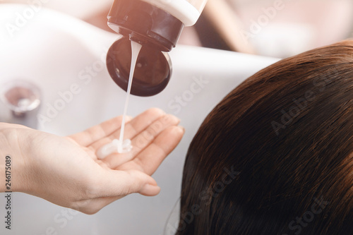 Girl in beauty salon. Wash your hair, care, health. Process of washing head hairdresser
