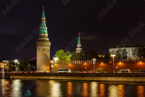 Towers of Moscow Kremlin on a background of Kremlevskaya embankment of Moskva river. Night landscape of Moscow historical center