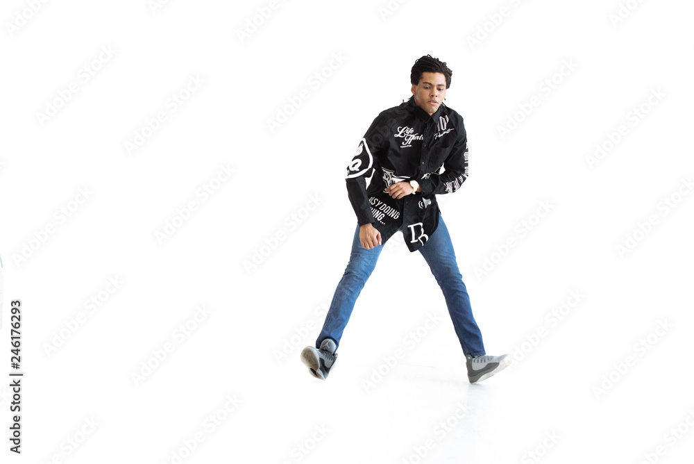 Young and stylish modern dancer. dancer with dreadlocks in a black shirt in a dance studio. Studio. White background. Young and stylish modern dancer. dancer with dreadlocks in a black shirt in a dance studio. Studio. White background.