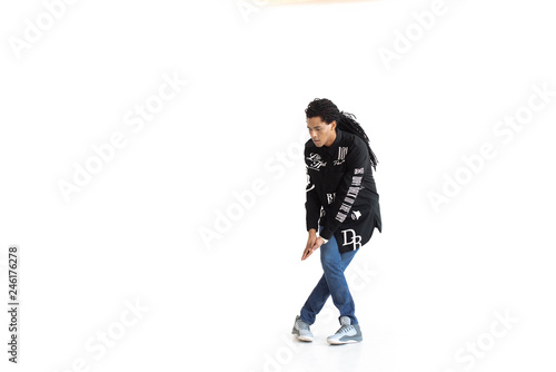 Young and stylish modern dancer. dancer with dreadlocks in a black shirt in a dance studio. Studio. White background.