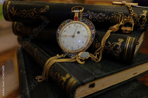 Vintage pocket Watch on a pile of old books.