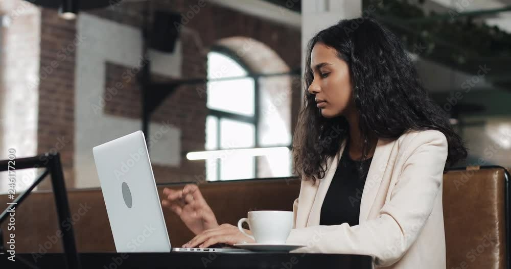 Young business woman finishing her work on laptop and and relaxed at modern office Young business woman finishing her work on laptop and and relaxed at modern office