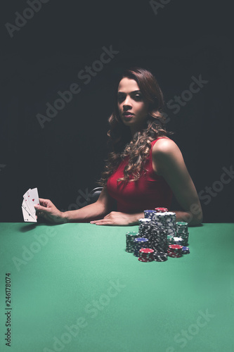 pretty young woman gambling on green table © ASDF