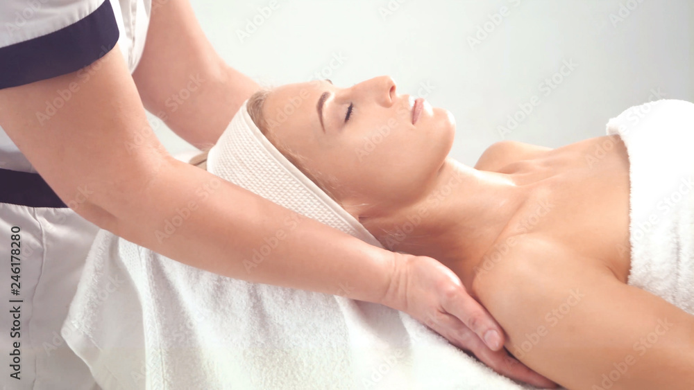 Young attractive woman getting spa treatment over white background. Young attractive woman getting spa treatment over white background.