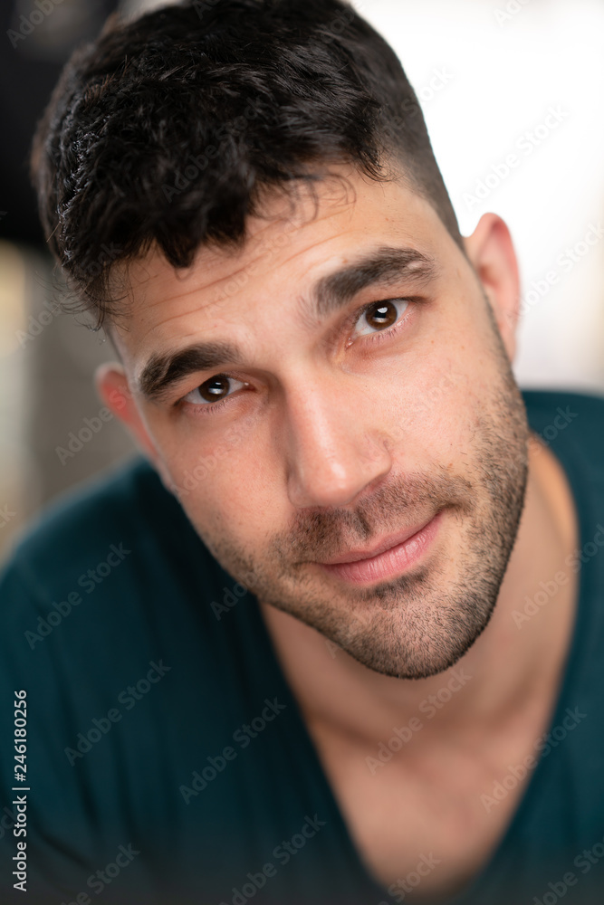 Handsome caucasian white male with black short hair and stubble with blue t shirt flirting Handsome caucasian white male with black short hair and stubble with blue t shirt flirting
