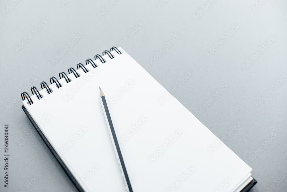 notepad on a grey abstract background with copy space, minimal style. Flat lay blog mock-up. Top view of open spiral blank notebook. Several onbject top horizontal view. notepad on a grey abstract background with copy space, minimal style. Flat lay blog mock-up. Top view of open spiral blank notebook. Several onbject top horizontal view.