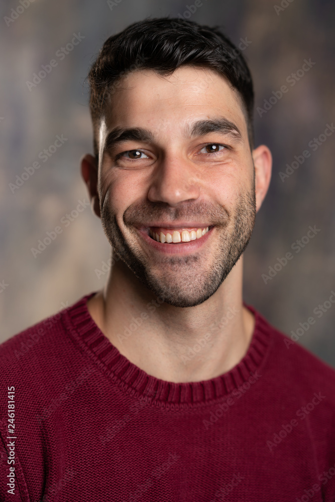 Obraz premium Handsome caucasian white male with black short hair and stubble and burgundy sweater jersey