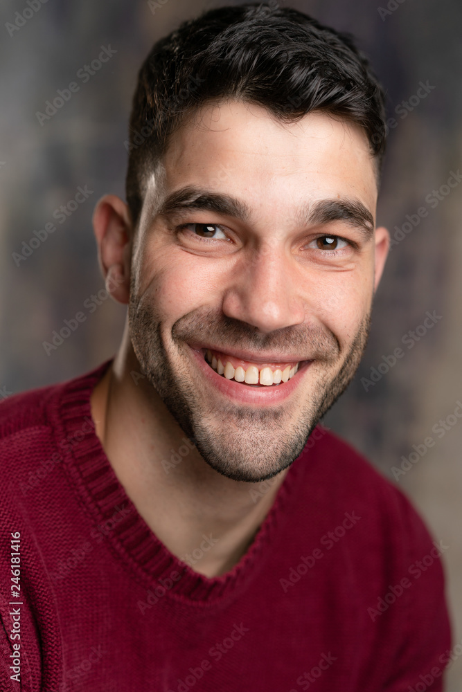 Handsome caucasian white male with black short hair and stubble and burgundy sweater jersey Handsome caucasian white male with black short hair and stubble and burgundy sweater jersey