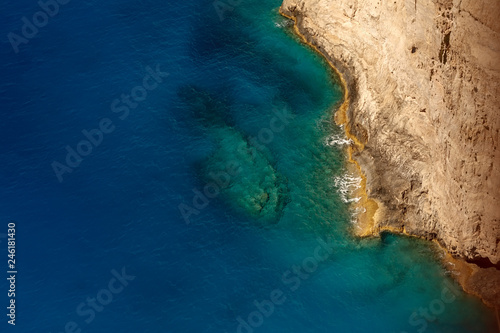 top view from the top of a cliff on a clear blue sea