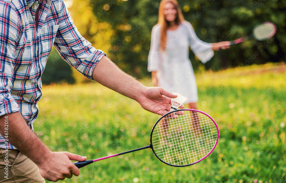 Couple playing badminton in the park. Sport, recreation, lifestyle, love  concept Stock Photo | Adobe Stock