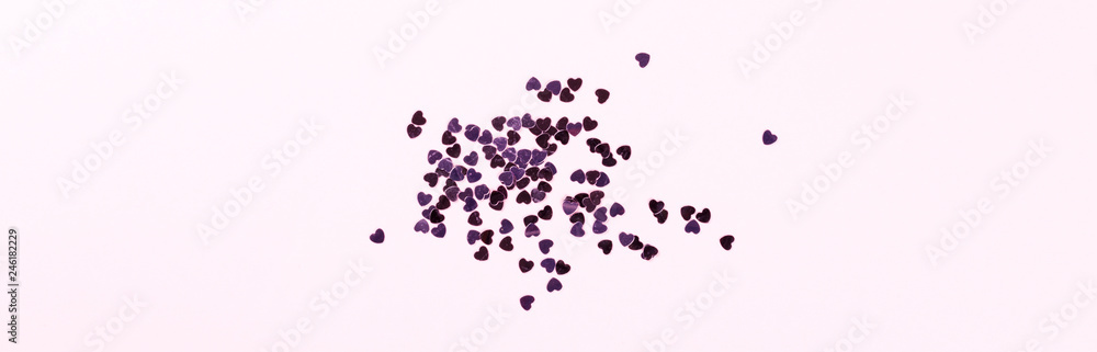 Flat lay top view glitter confettiin the shape of a heart on pink background.Greeting card Festive holiday pastel backdrop Love. Birthday congratulations St. Valentine's Day Banner. Flat lay top view glitter confettiin the shape of a heart on pink background.Greeting card Festive holiday pastel backdrop Love. Birthday congratulations St. Valentine's Day Banner.