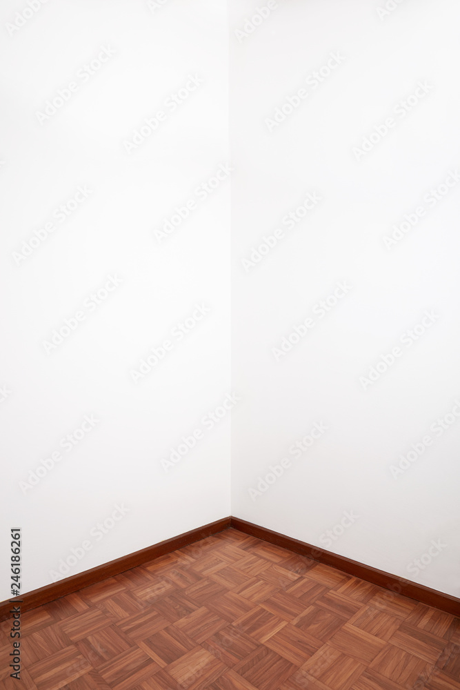 Room corner with brown wooden tiled floor and white blank wall Room corner with brown wooden tiled floor and white blank wall
