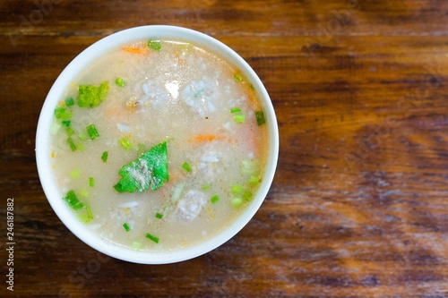Rice Soup with pork on wooden background
