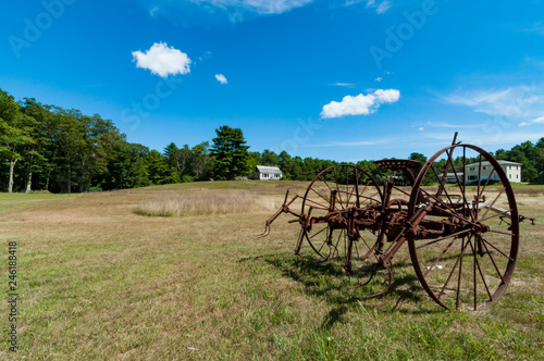 old plough on a farm landscape in Maine, USA
