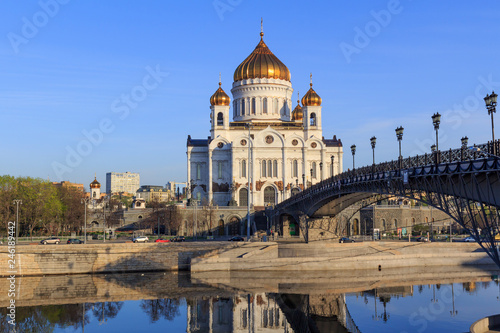 Cathedral of Christ the Saviour and Patriarshiy Bridge over Moskva river on a blue sky background in sunny spring morning