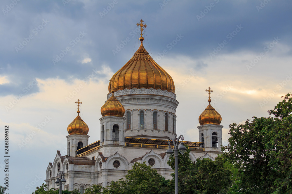 Golden domes of Cathedral of Christ the Saviour in Moscow against dramatic sky