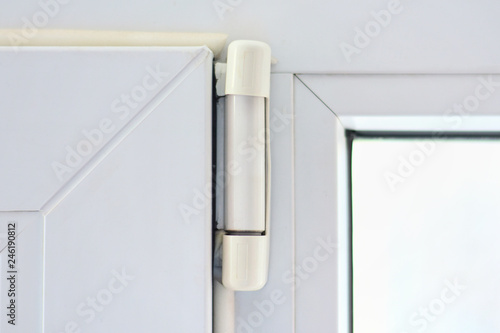 Furniture elements of white plastic window with sealant on the edge and hinge connector. Rubber hermetical protection on plastic window frame with blurred glass. Aluminum window profile inside  photo