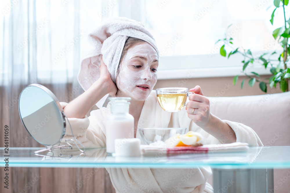 Beautiful happy woman with natural cosmetic mask on her face. Skin care and Spa treatments Beautiful happy woman with natural cosmetic mask on her face. Skin care and Spa treatments