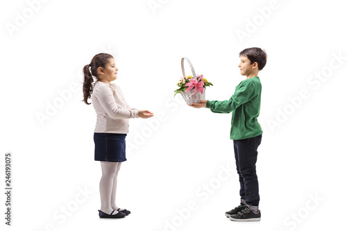 Little boy giving a basket with flowers to a little girl © Ljupco Smokovski
