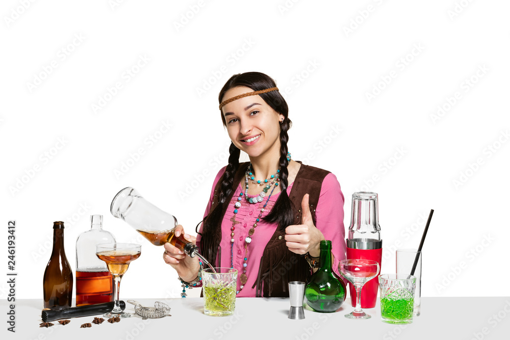 Expert female barman is making cocktail at studio isolated on white background. International barman day, bar, alcohol, restaurant, party, pub, nightlife, cocktail, nightclub concept Expert female barman is making cocktail at studio isolated on white background. International barman day, bar, alcohol, restaurant, party, pub, nightlife, cocktail, nightclub concept