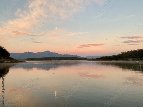 Pink  purple and orange hues in the sky over Lake El Salto  a famous bass fishing spot in Sinaloa  Mexico  at dawn
