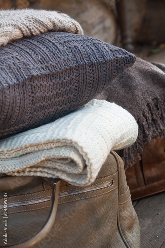 Close up of cushion, bag and bed clothes