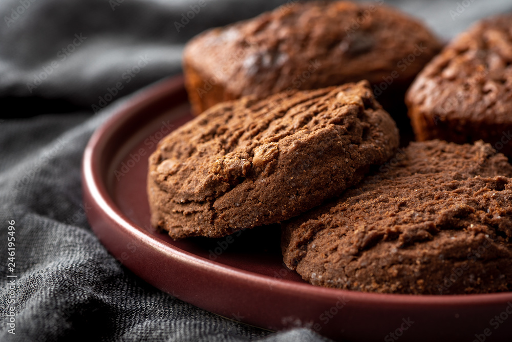Chocolate cookies on a plate, dark background. Chocolate cookies on a plate, dark background.