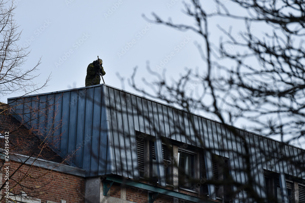 sniper securing a perimeter from a rooftop sniper securing a perimeter from a rooftop