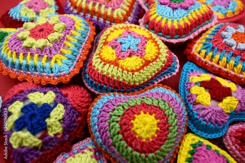 Knitted hearts of colored yarn closeup. Valentine's Day, background, design, creative. © Oxana