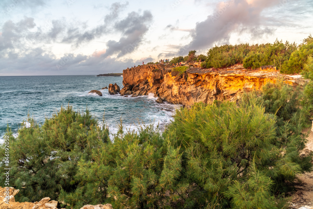 Visitors gathered on the cliff to watch the sunrise over the ocean, Poipu, Koloa, Kauai, Hawaii