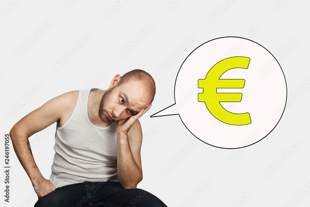 bald sad man sits and thinks about money and a small salary in Euro bald sad man sits and thinks about money and a small salary in Euro