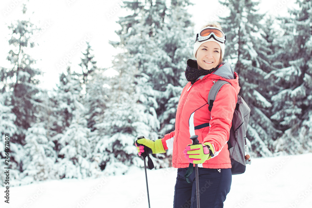 Happy young woman skier portrait winter sport in mountains