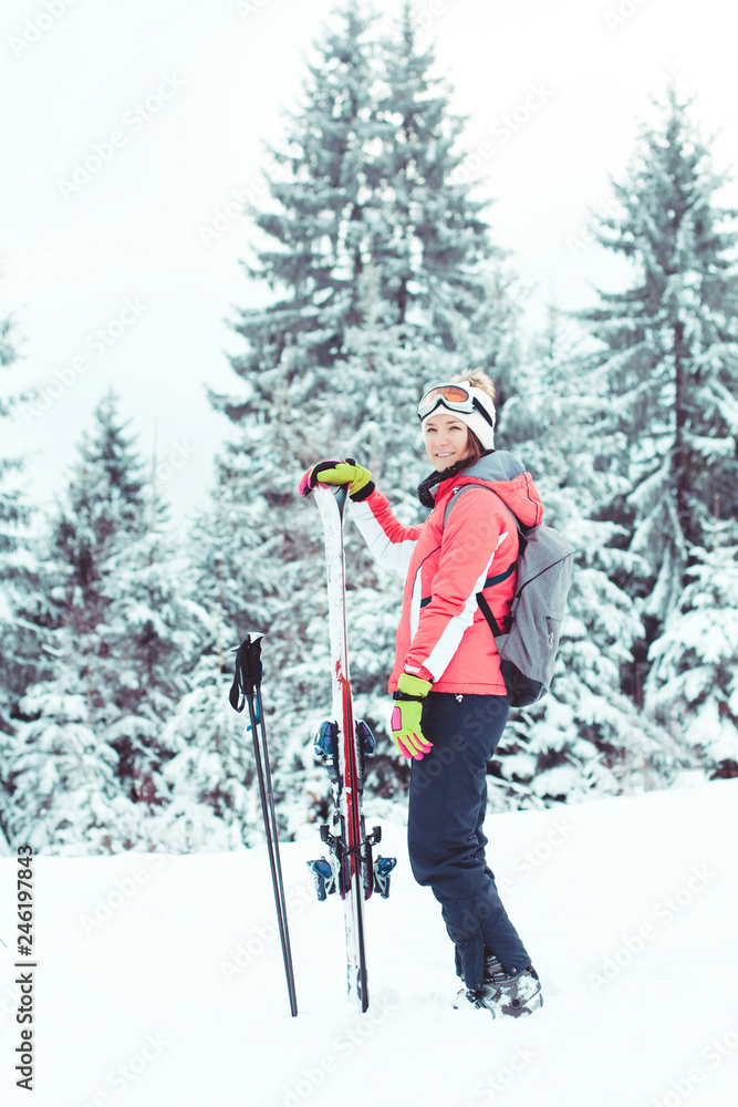 Young woman skier portrait outdoors in winter mountain