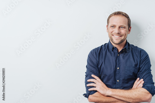 Young man with a thoughtful pleased smile