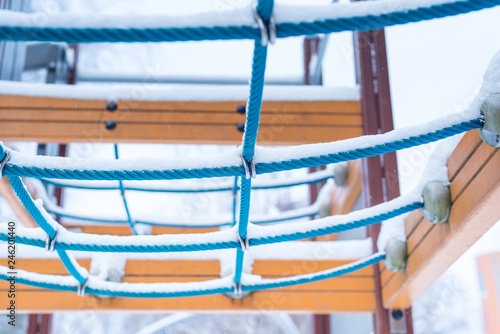 Empty snow covered playground in winter time photo