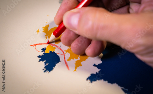 Hand drawing a red line between the UK and Northern Ireland, Backstop and Brexit concept. The Backstop solution for the Irish border is one of the main EU and UK negotiations. photo