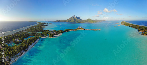 Aerial panoramic landscape view of the island of Bora Bora in French Polynesia with the Mont Otemanu mountain surrounded by a turquoise lagoon, motu atolls, re photo