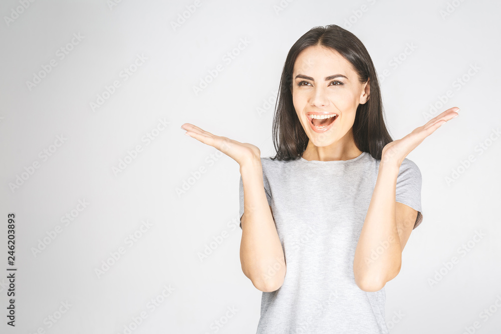 Wow! It's amazing! Portrait of a smiling pretty woman looking up isolated on a white background.