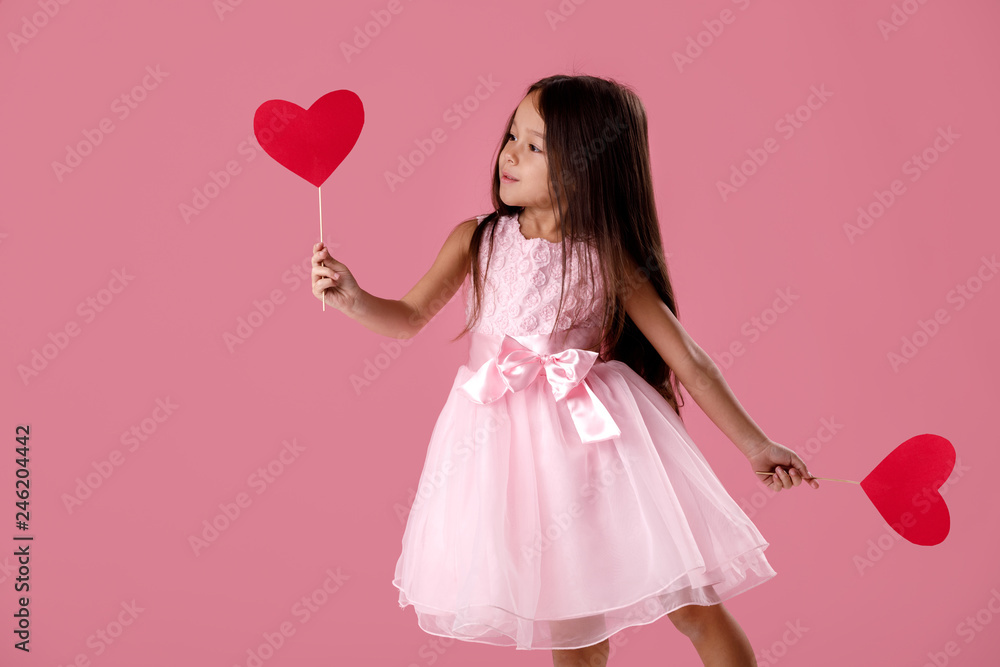 cute little girl in a pink dress holding a paper heart cute little girl in a pink dress holding a paper heart