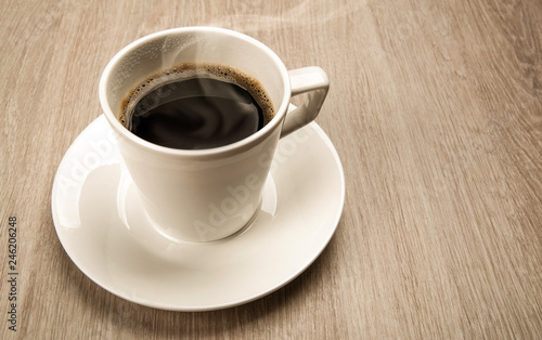 coffee still life from a cup of black coffee on a wooden table