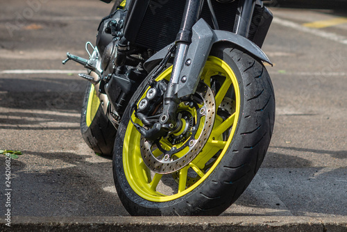 closeup tire and dish bake of street motorcycle - image