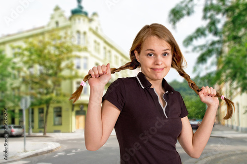 Portrait of embarrassed girl standing on a street photo