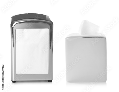 Set of different modern napkin holders with paper serviettes on white background