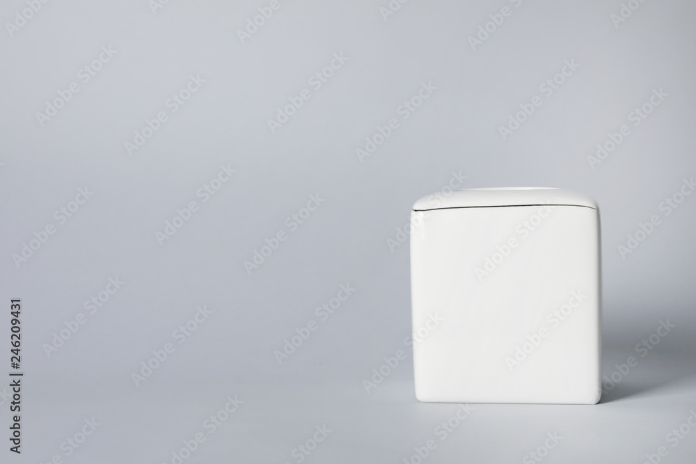 Empty napkin holder on gray background. Space for text Empty napkin holder on gray background. Space for text