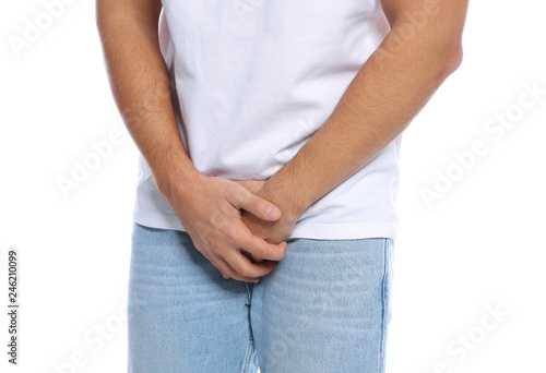 Man with itching crotch on white background, closeup
