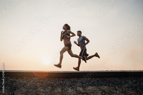 Young couple running on the street be running for exercise. fitness, sport, people, exercising ,running and lifestyle concept .