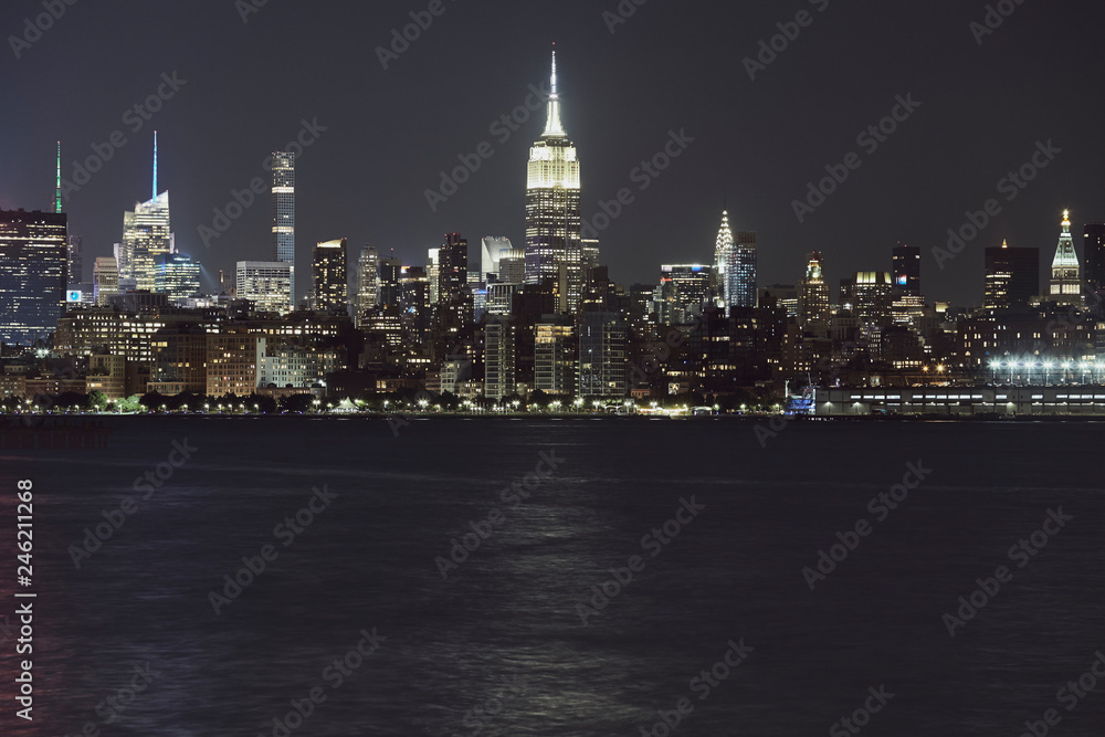 New York City skyline at night, color toning applied, USA.