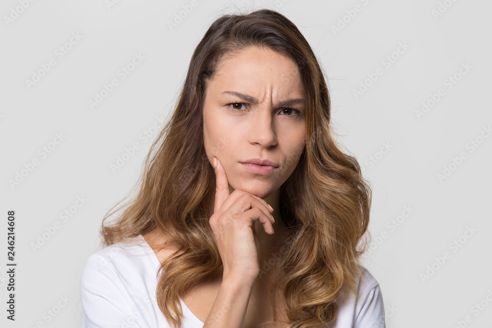 Puzzled perplexed young woman with distrustful face isolated on blank studio wall, unbelieving suspicious girl looking at camera doubtful uncertain bewildered criticize on white background portrait Puzzled perplexed young woman with distrustful face isolated on blank studio wall, unbelieving suspicious girl looking at camera doubtful uncertain bewildered criticize on white background portrait