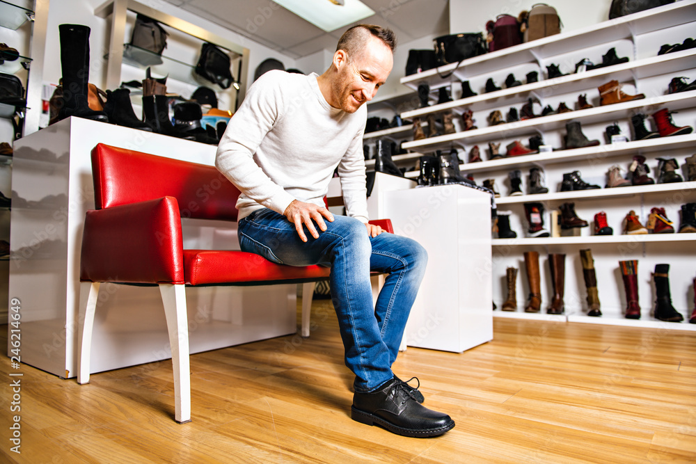 A man are looking for a new shoes in the shoe shop A man are looking for a new shoes in the shoe shop