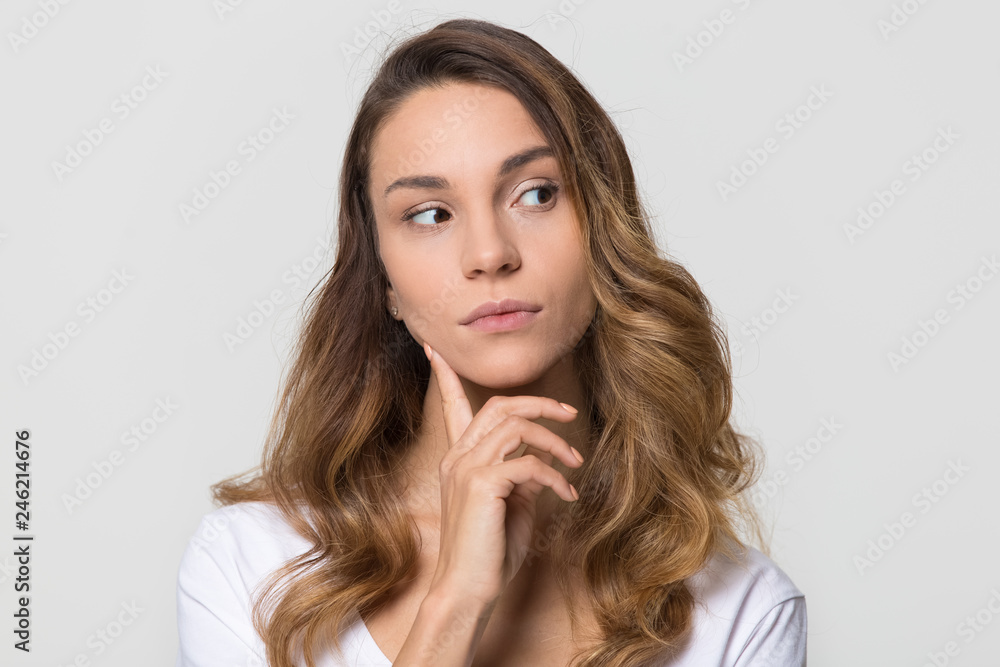 Thoughtful young woman looking away feeling doubt isolated on white studio wall, millennial girl with unsure face thinking of question considering uncertain about making decision on blank background Thoughtful young woman looking away feeling doubt isolated on white studio wall, millennial girl with unsure face thinking of question considering uncertain about making decision on blank background